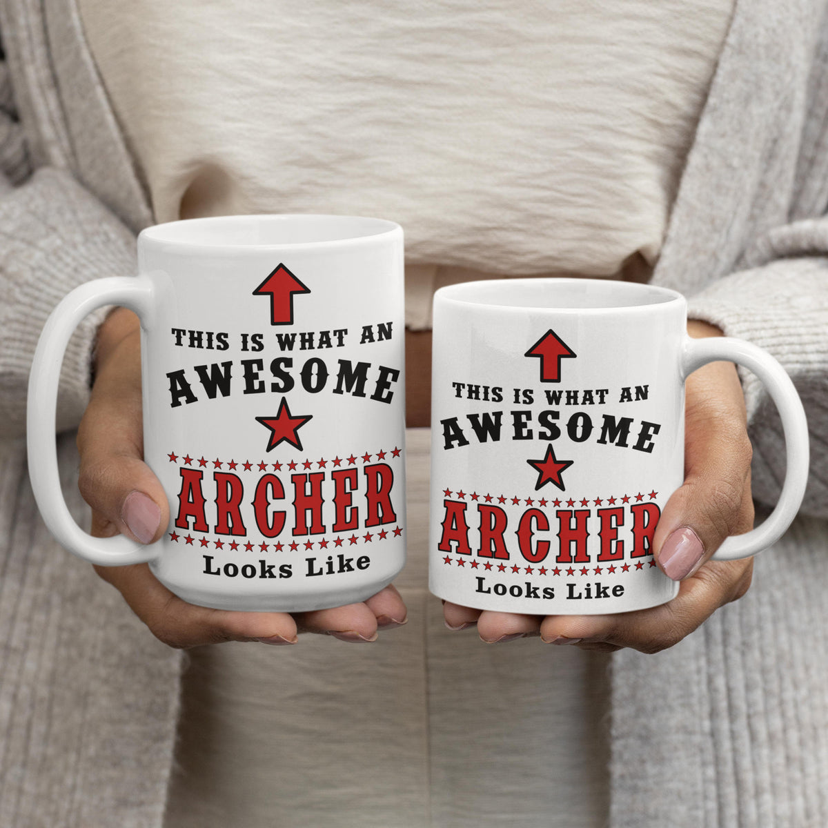 Woman holding 15oz and 11oz Awesome Archer mugs side by side showing size comparison
