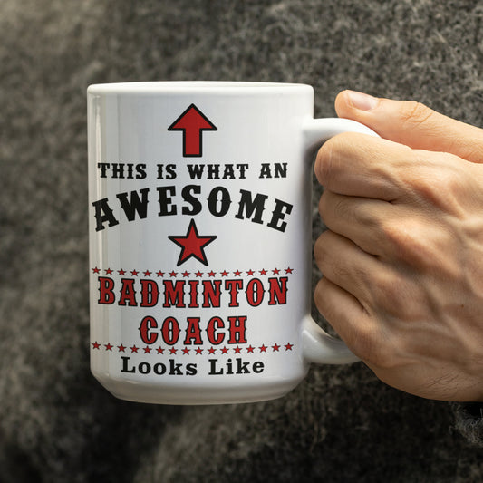 Hand holding a white 15oz "This Is What An Awesome Badminton Coach Looks Like" mug
