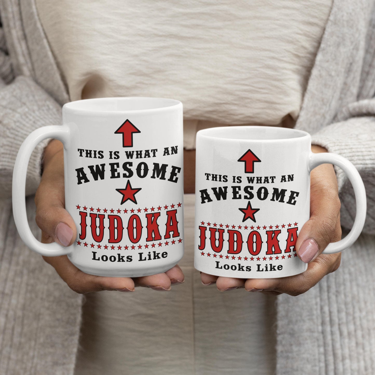Comparison of 15oz and 11oz Awesome Judoka mugs held side by side, showing size difference