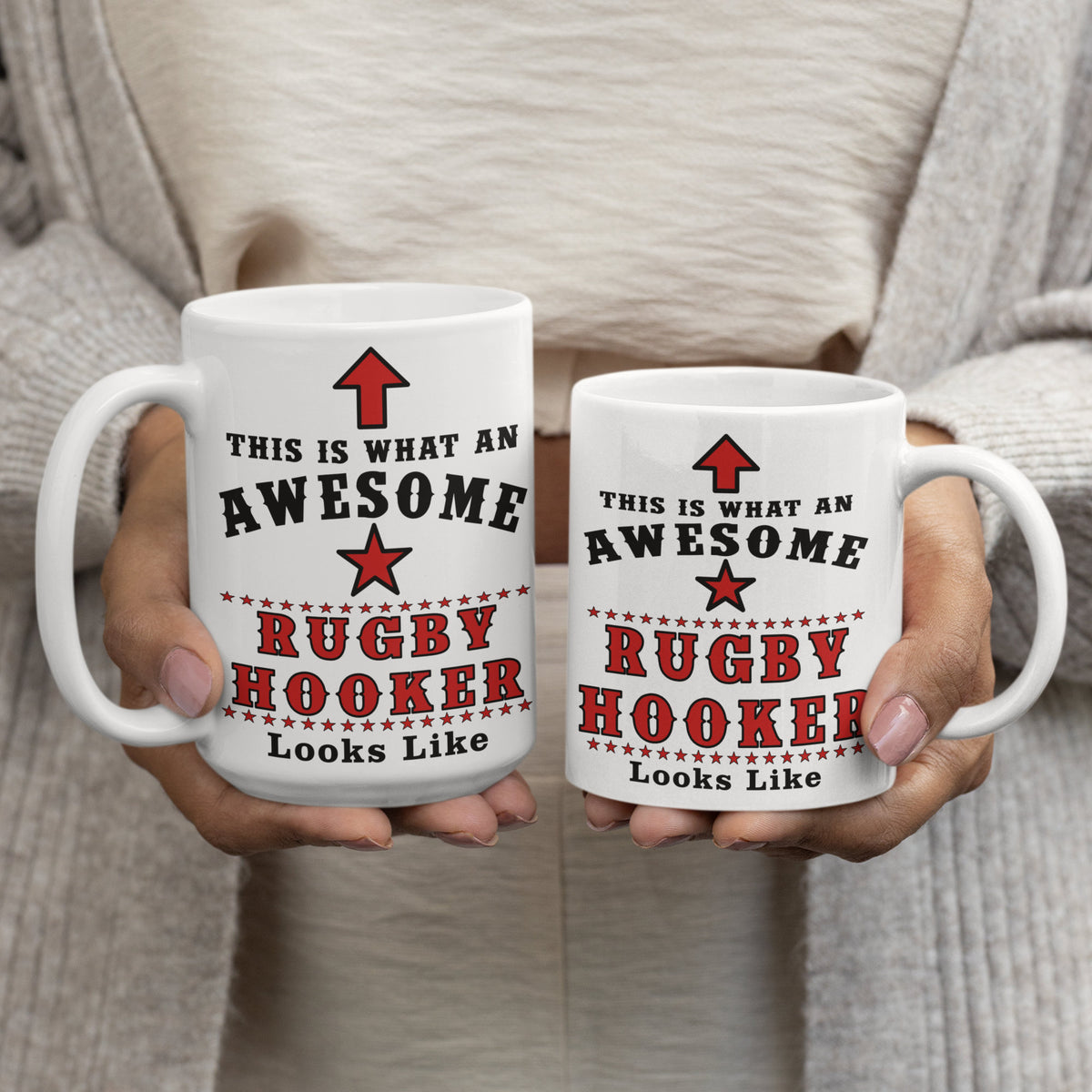 Woman holding 15oz and 11oz "This Is What An Awesome Rugby Hooker Looks Like" mugs side by side