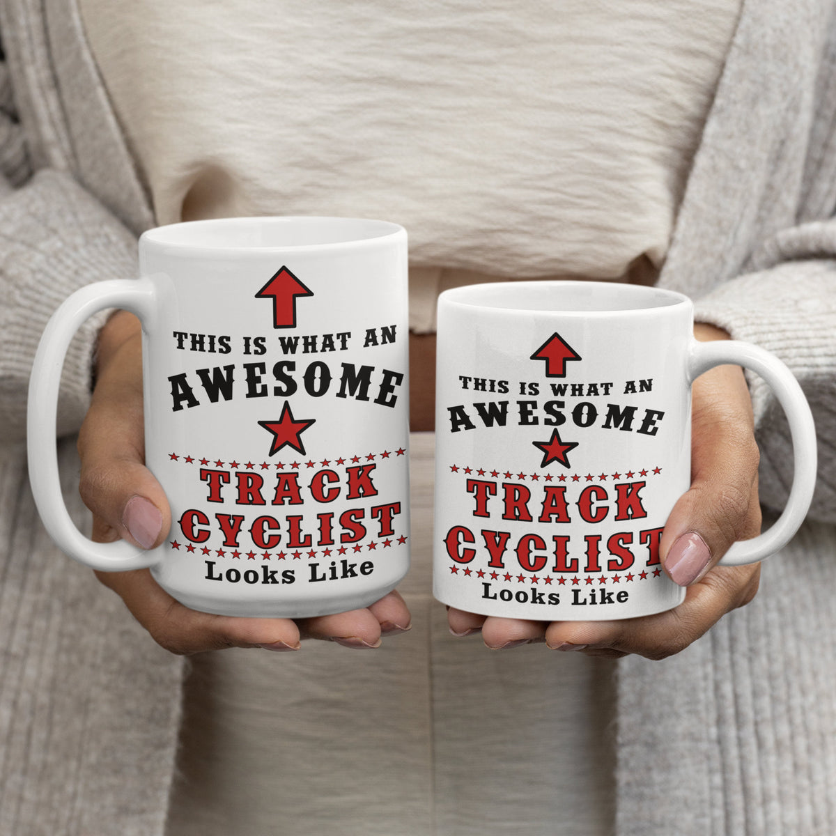 Two Track Cyclist mugs in 15oz and 11oz sizes held side by side, white mug with red star design reading This Is What An Awesome Track Cyclist Looks Like