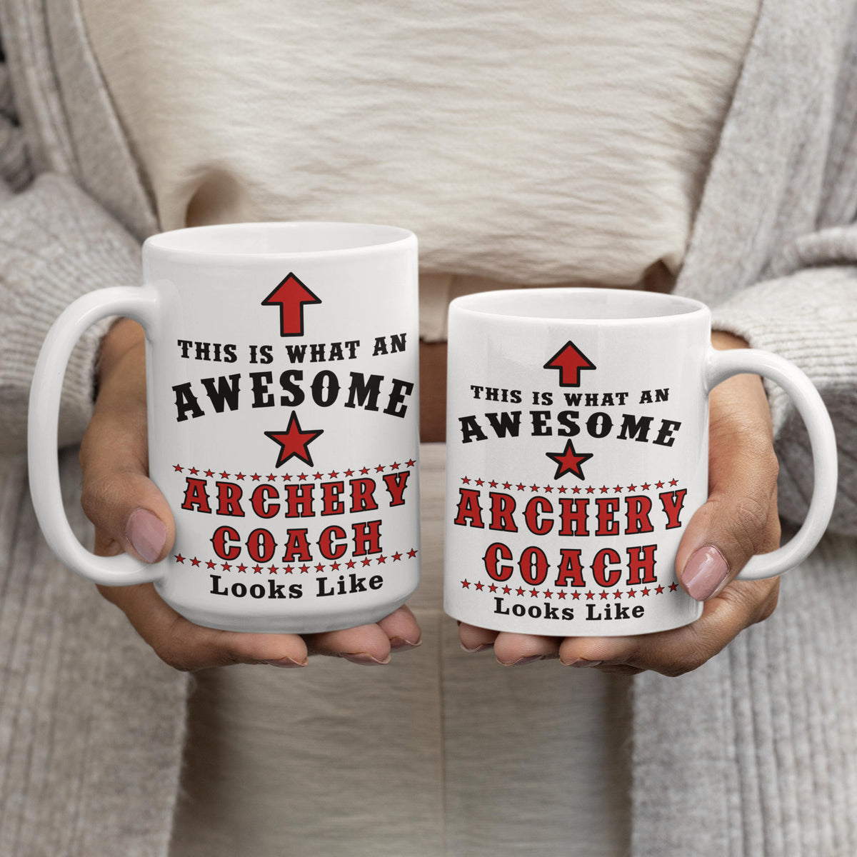 Woman holding two Awesome Archery Coach mugs side by side, comparing 15oz and 11oz sizes