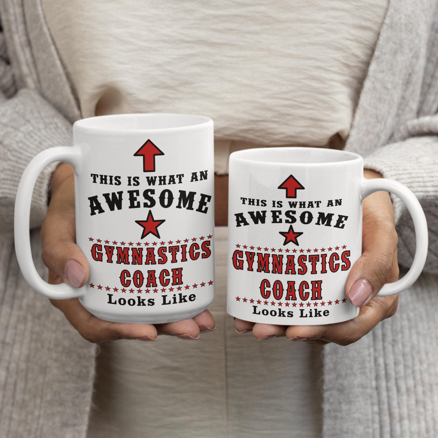 Two Awesome Gymnastics Coach mugs held side by side showing 15oz and 11oz size comparison, white mug with red and black text

