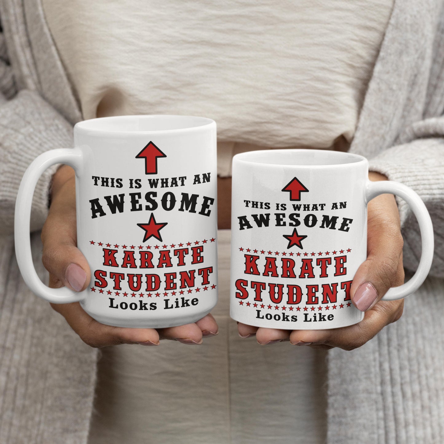 Two hands holding the 15oz and 11oz "Awesome Karate Student" mugs side by side, showing the size comparison