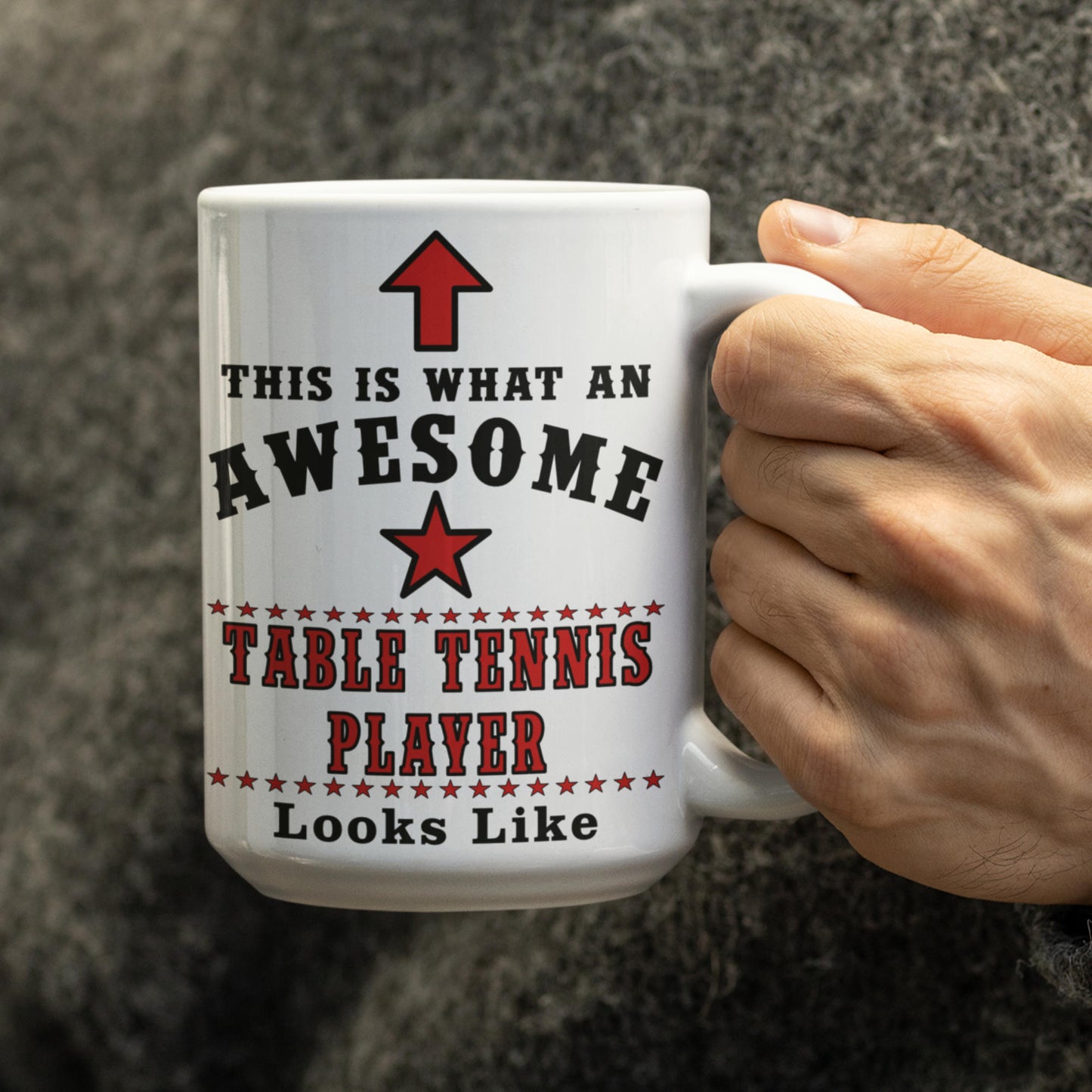 Hand holding a white 15oz table tennis player mug printed with "This Is What An Awesome Table Tennis Player Looks Like"