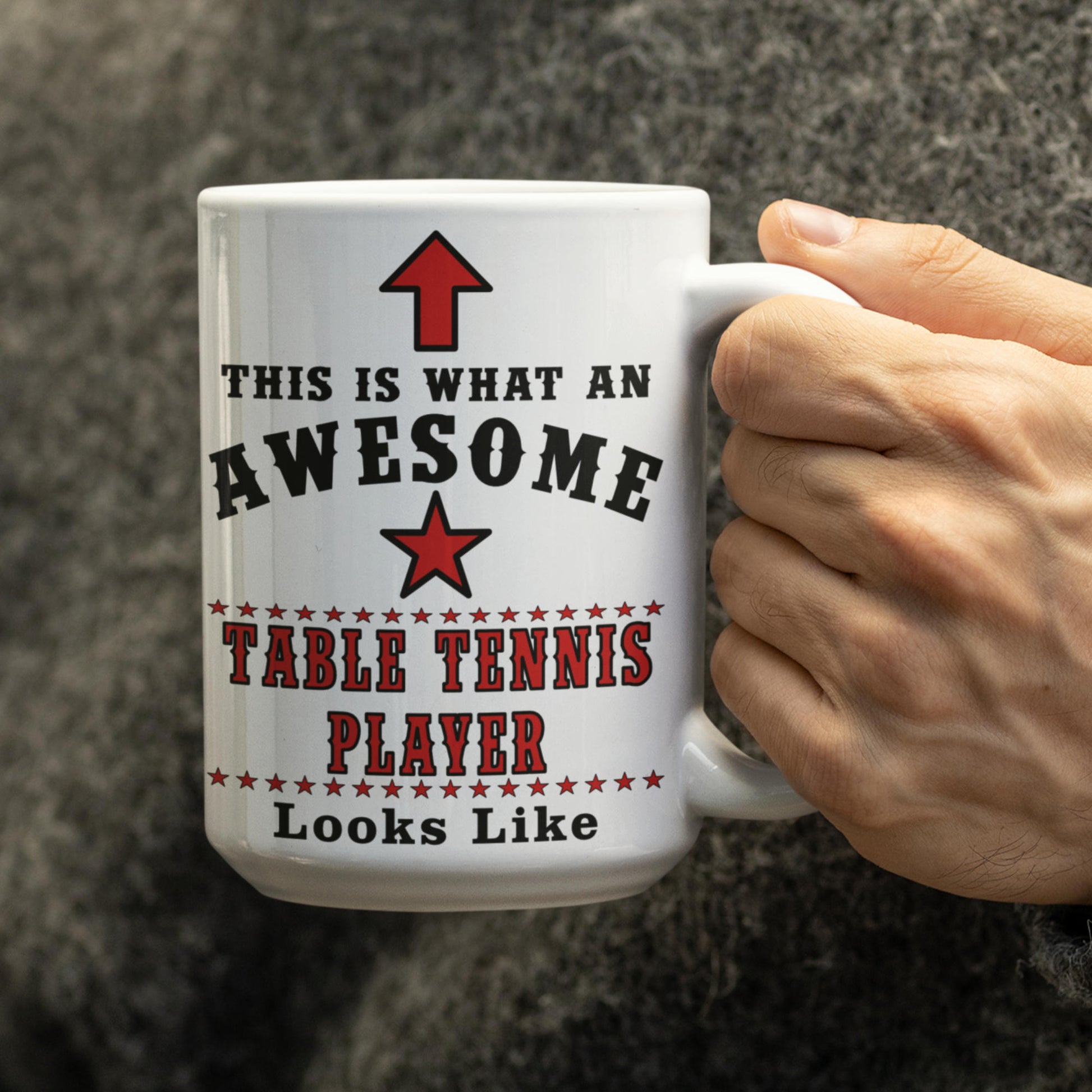 Hand holding a white 15oz table tennis player mug printed with "This Is What An Awesome Table Tennis Player Looks Like"