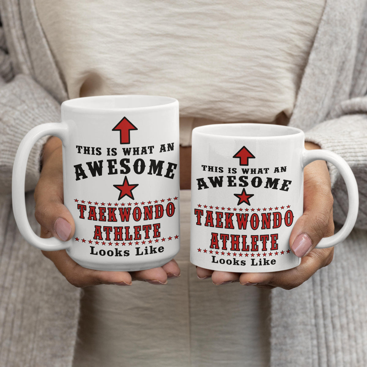 Woman holding a 15oz and 11oz Awesome Taekwondo Athlete mug side by side, showing size comparison