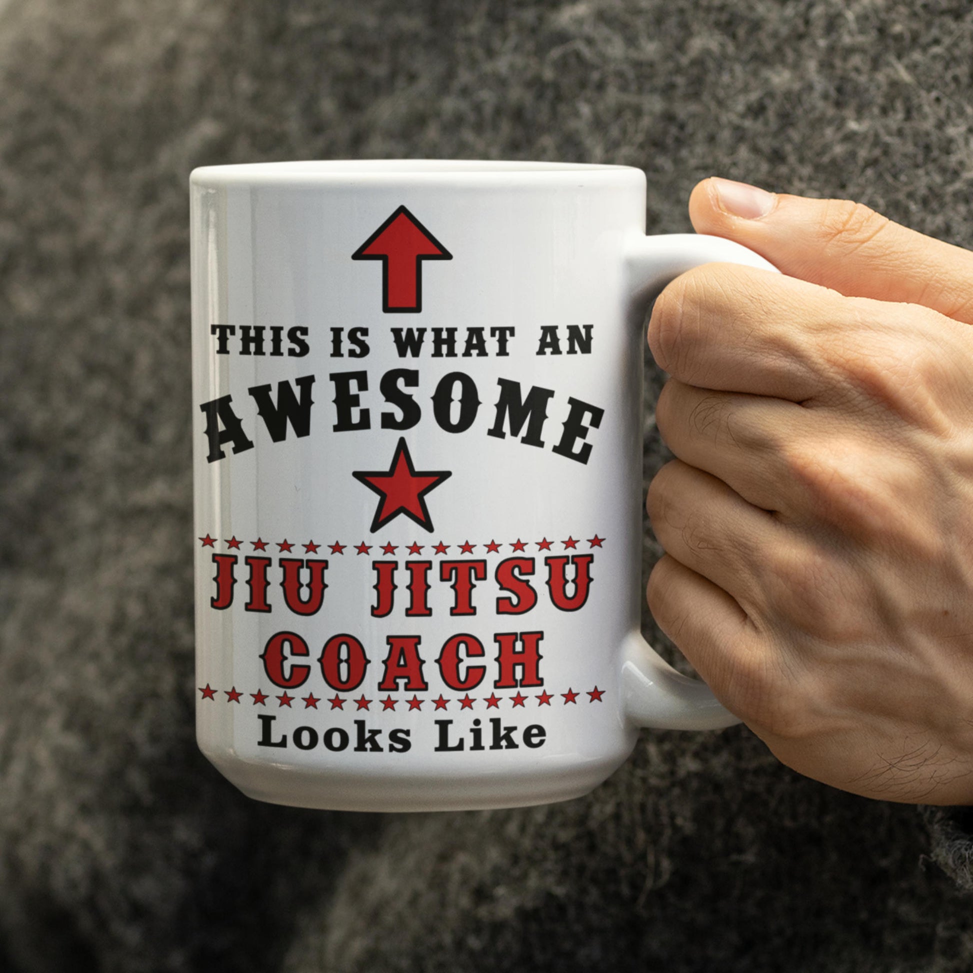 Hand holding a 15oz Awesome Jiu Jitsu Coach mug, funny BJJ gift for grappling coaches
