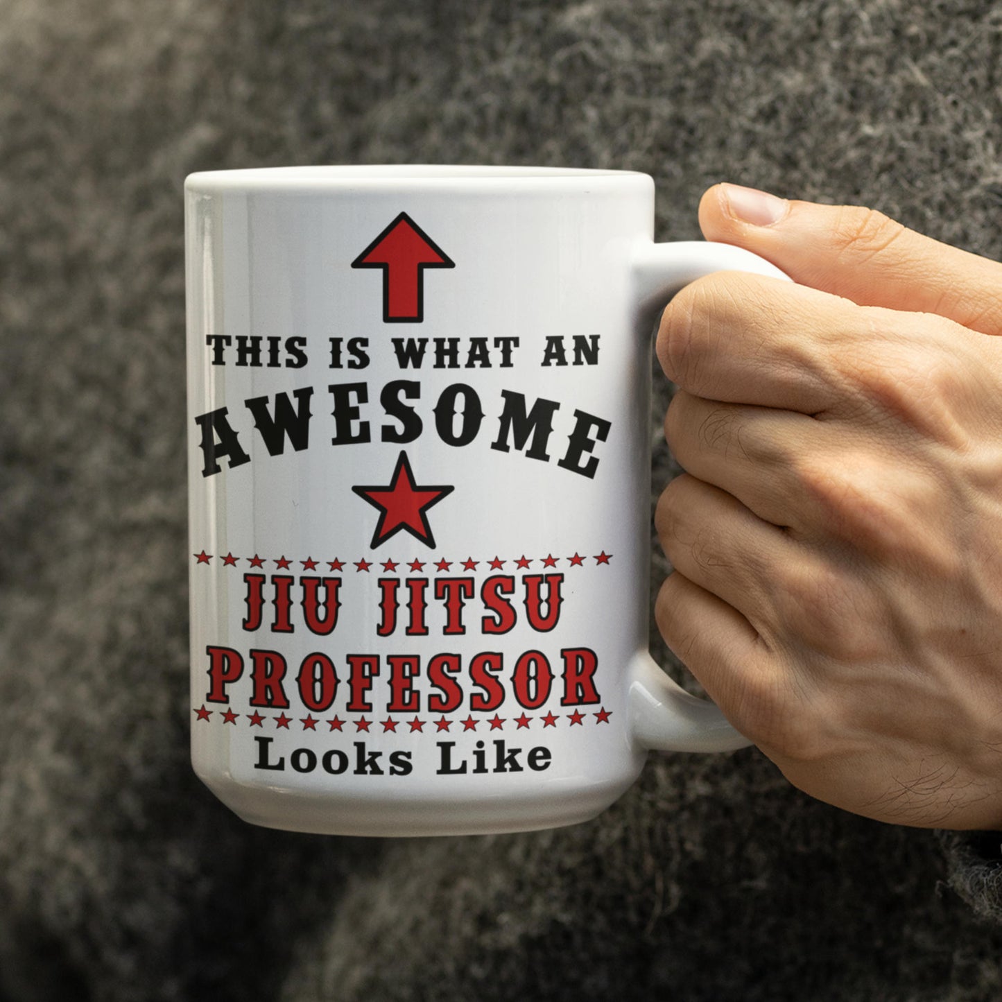 Hand holding white 15oz Awesome Jiu Jitsu Professor mug showing red star and text design