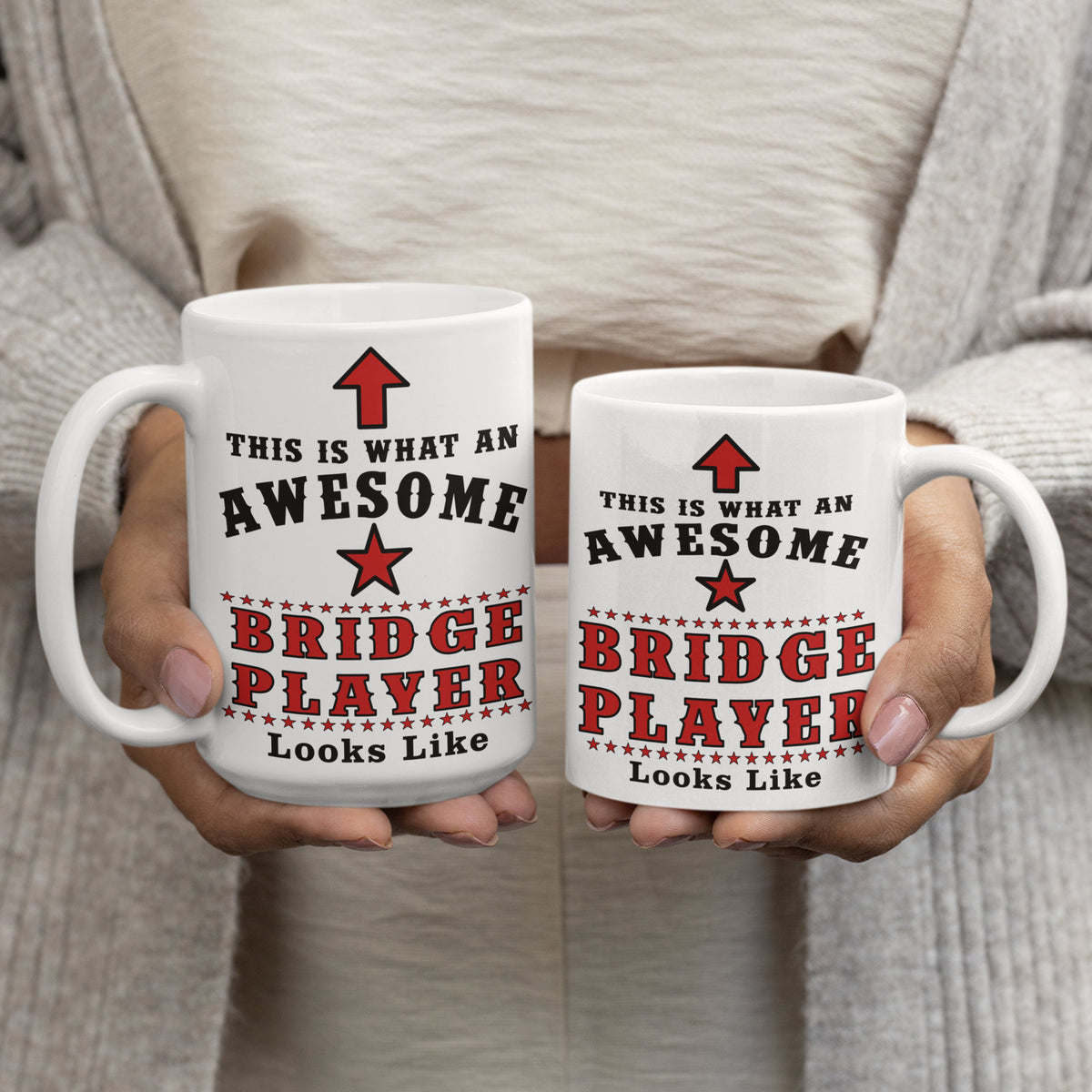 15oz and 11oz Bridge Player mugs held side by side showing the size difference, both printed with "This Is What An Awesome Bridge Player Looks Like"
