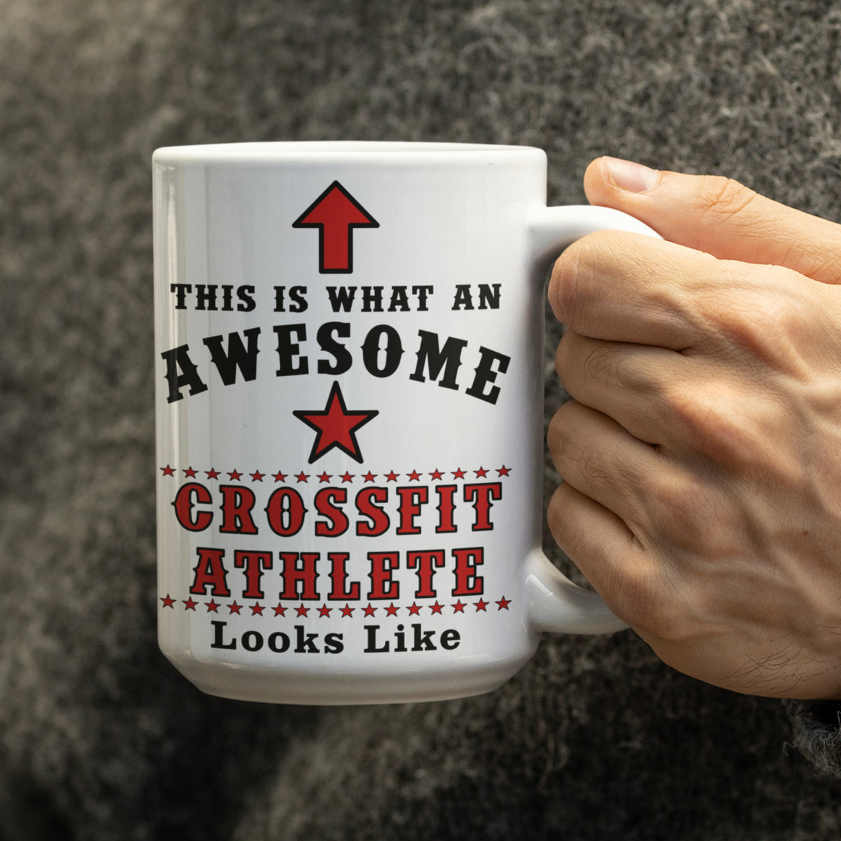 Man in grey jumper holding a large 15oz white mug with "This is what an awesome CrossFit athlete looks like" printed in black and red