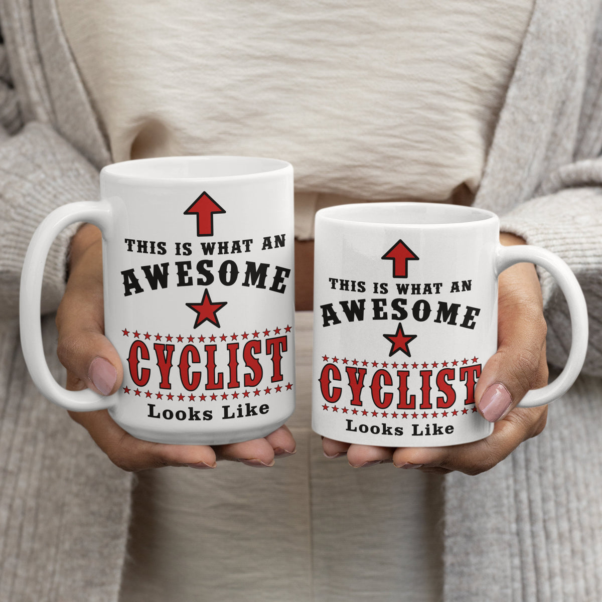 15oz and 11oz "Awesome Cyclist" mugs held side by side, showing size comparison