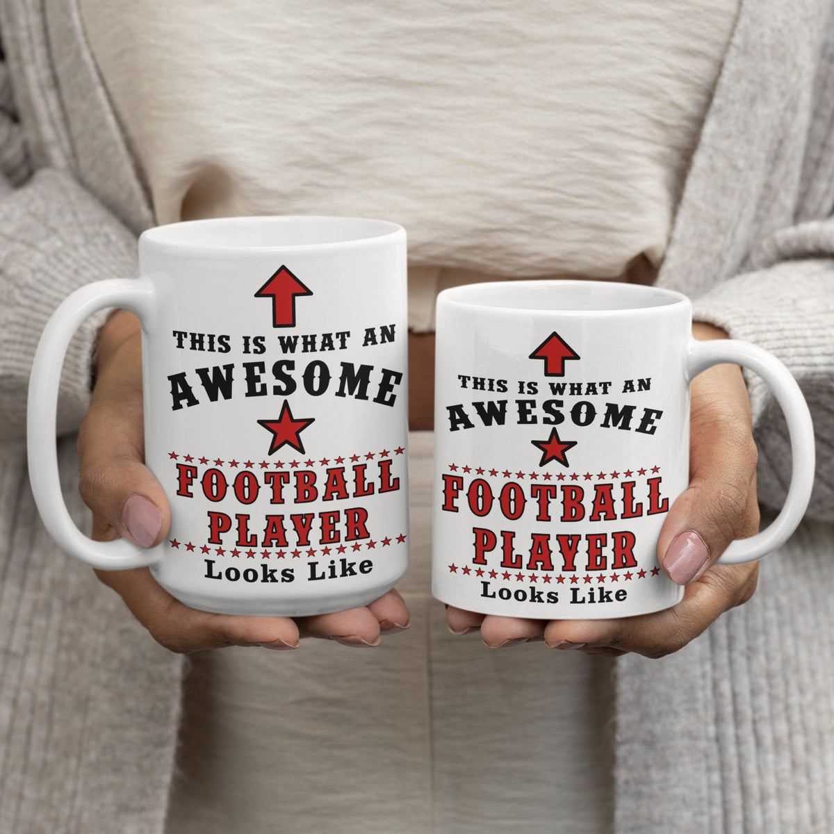 Person holding a 15oz and 11oz "Awesome Football Player" mug side by side, showing size comparison