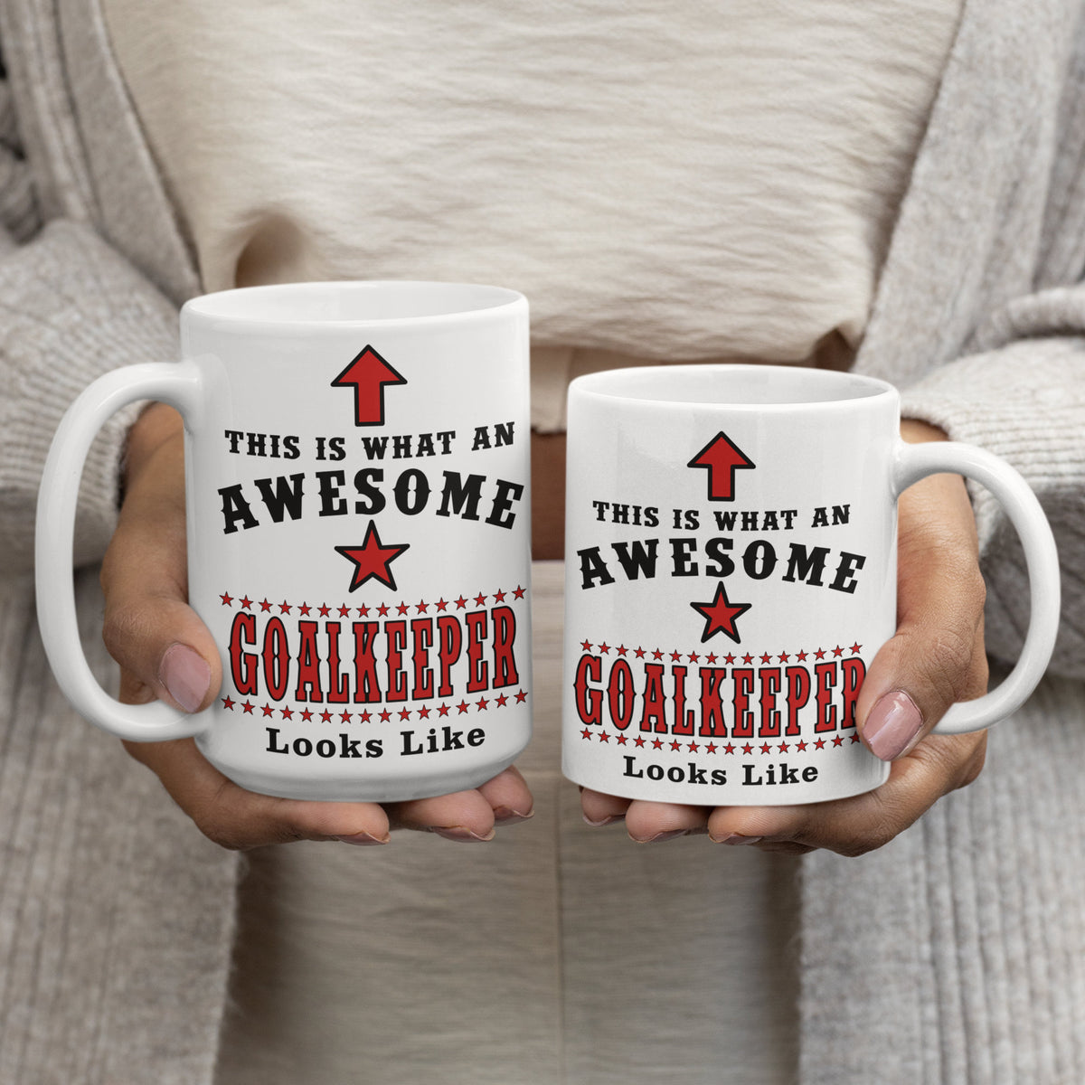 Two "Awesome Goalkeeper" mugs held side by side, showing 15oz and 11oz size comparison