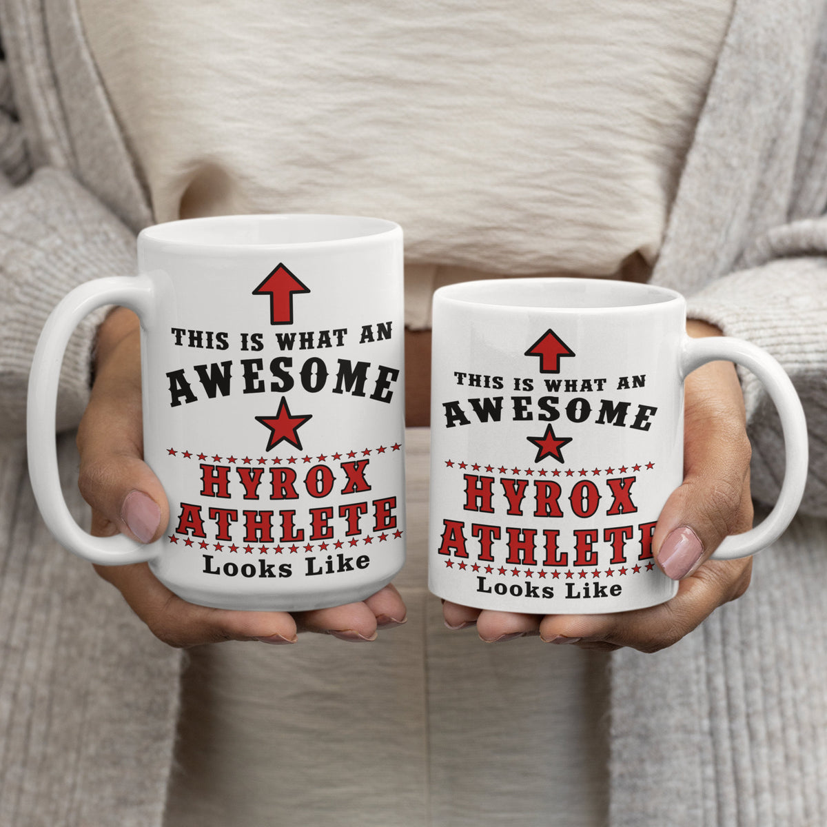 Two Hyrox Athlete mugs, 15oz and 11oz, held side by side showing size comparison
