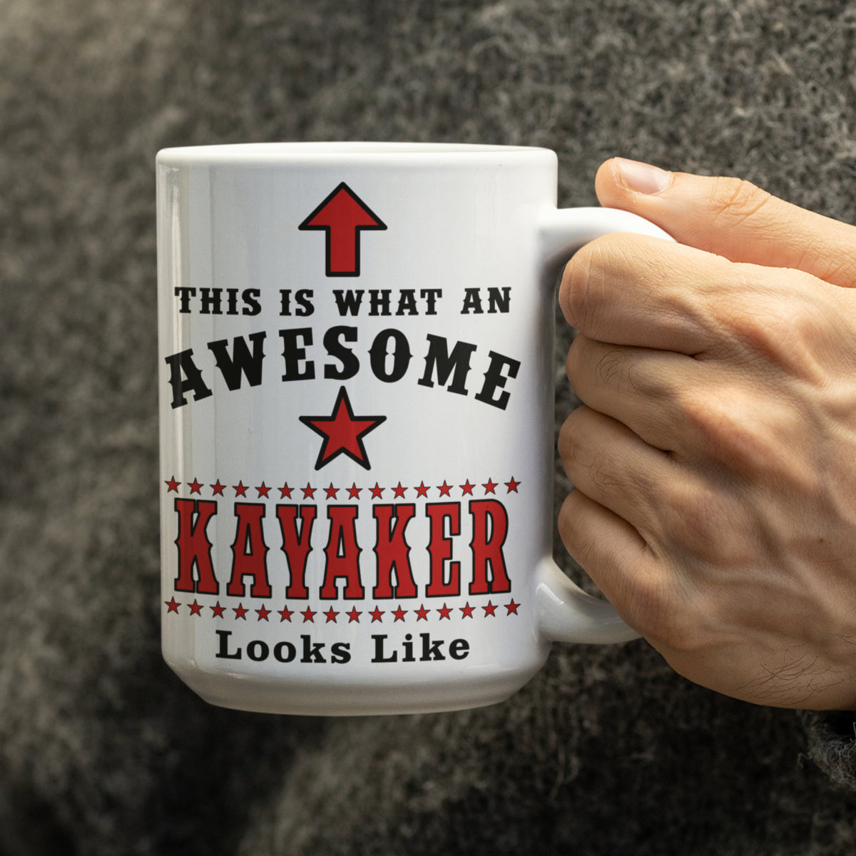 Man holding a large white 15oz "This Is What An Awesome Kayaker Looks Like" mug wearing a grey wool jumper
