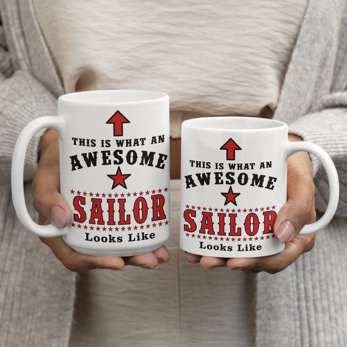Woman holding two "This Is What An Awesome Sailor Looks Like" mugs showing 15oz and 11oz size comparison